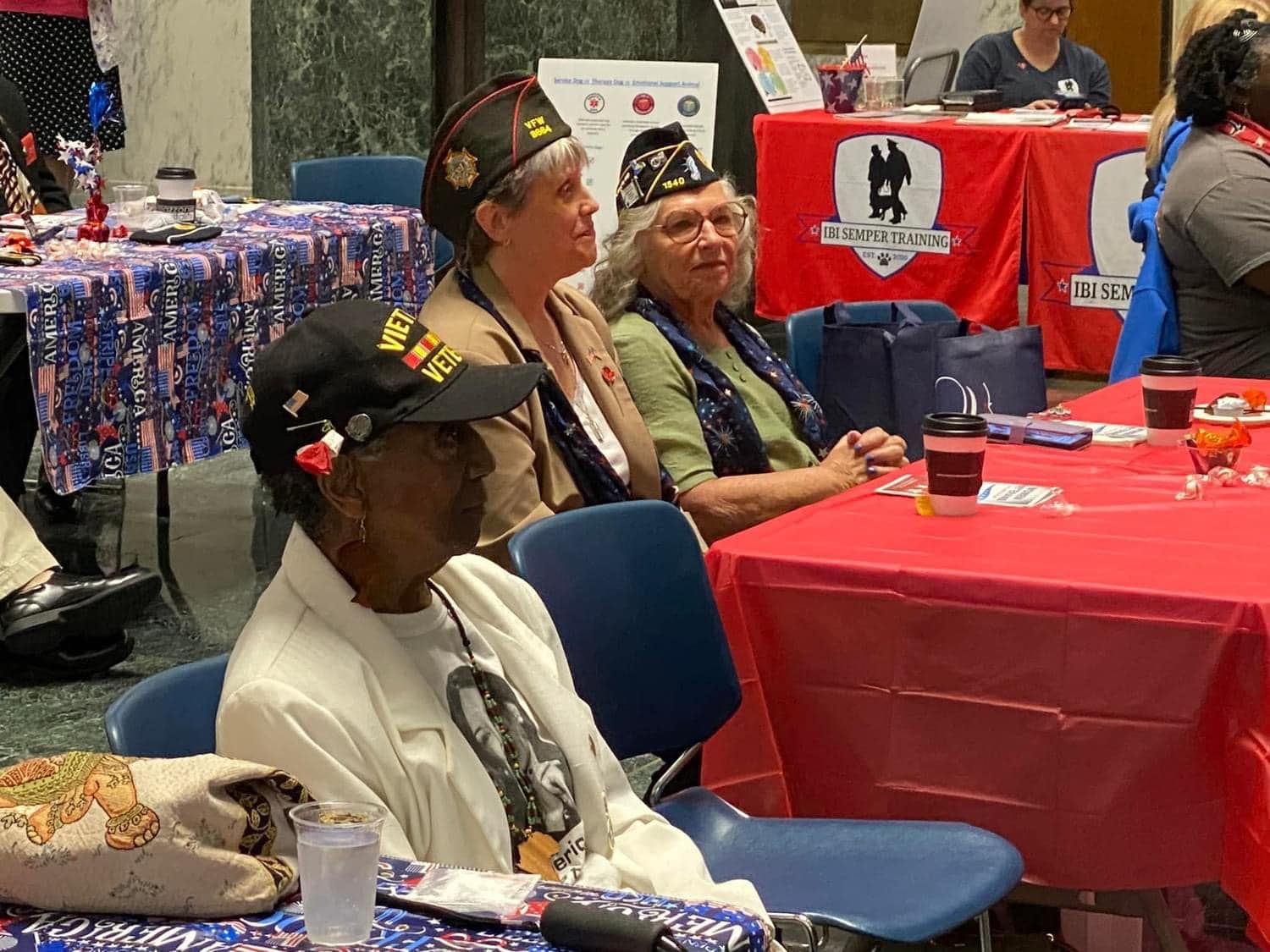 A group of people are sitting at a table drinking coffee.