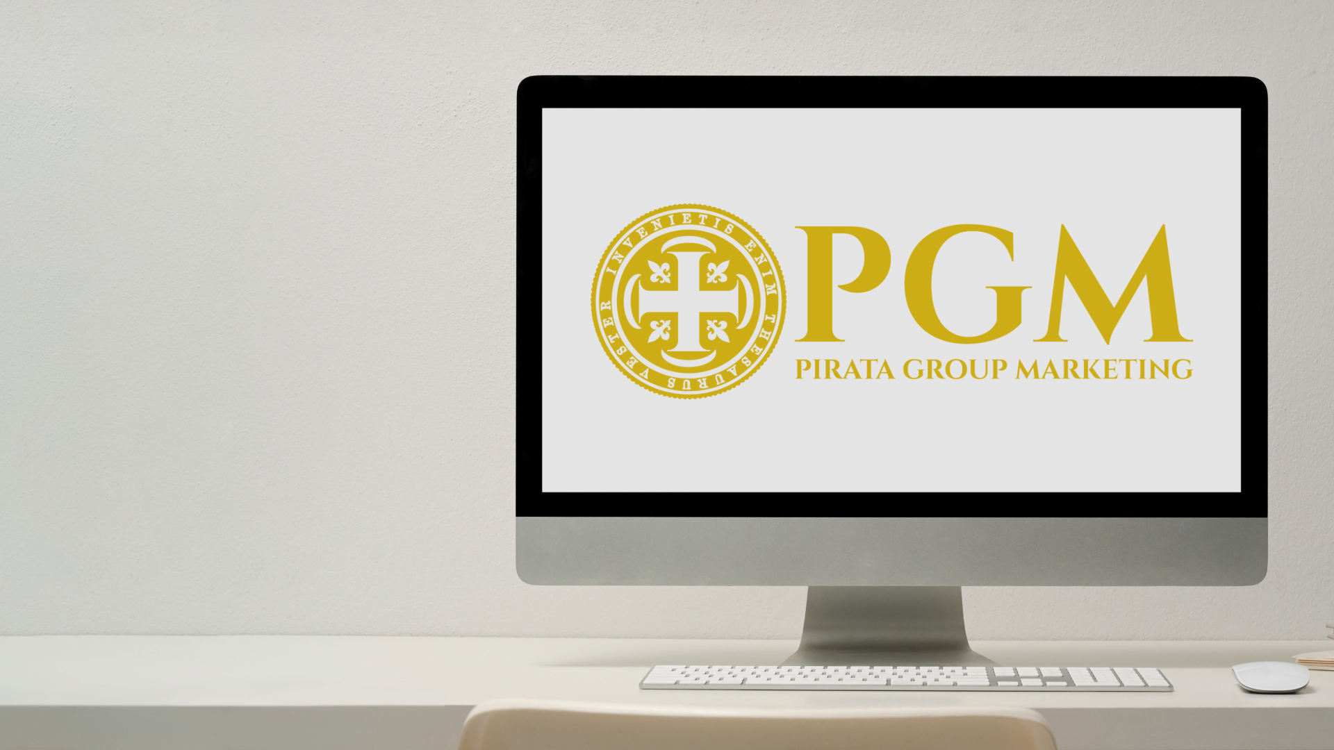 Desktop monitor displaying a gold PGM logo on a white background