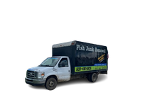 A white truck with a black tarp that says fish junk removal on it.