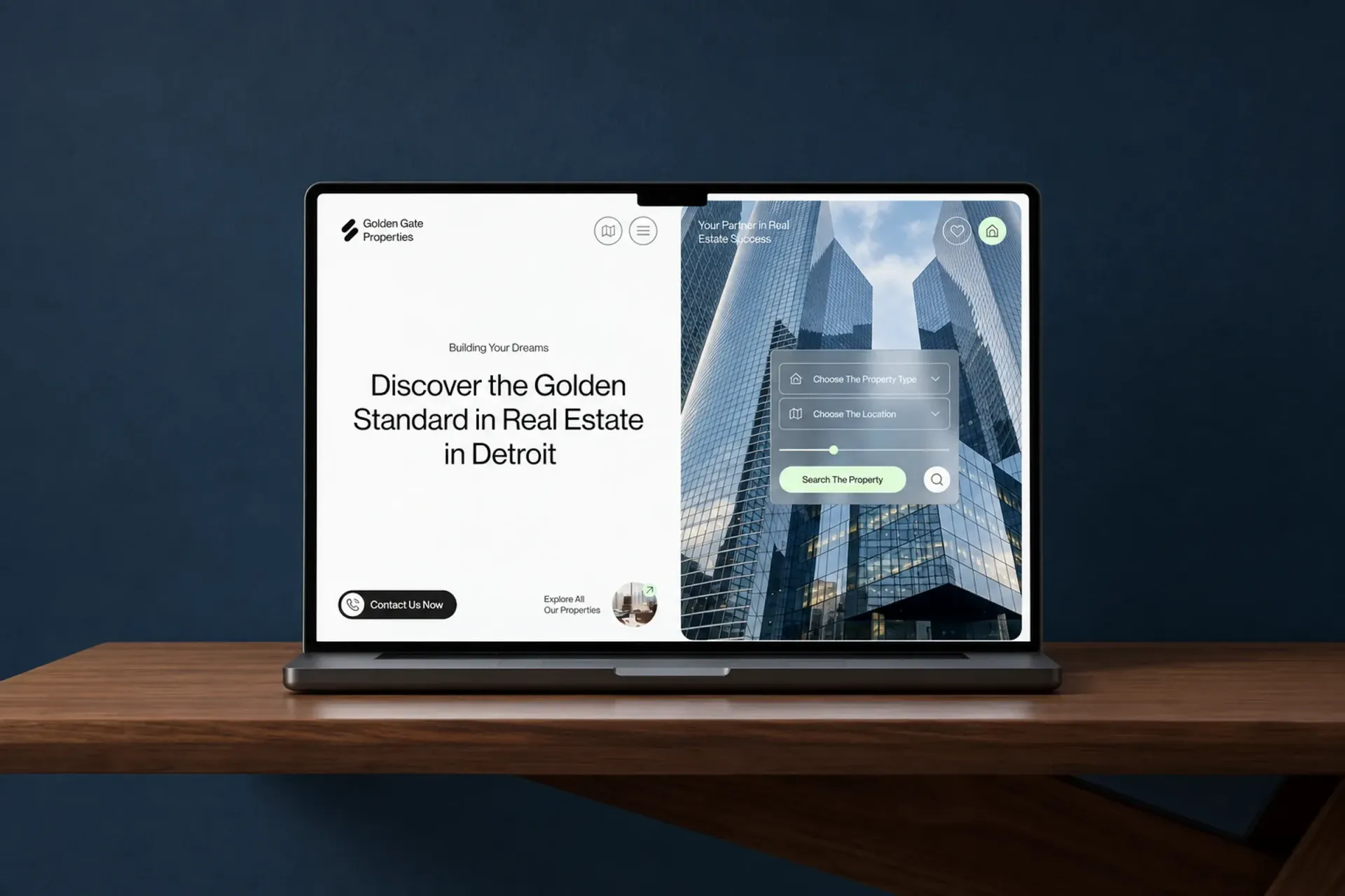 Laptop displaying a modern real estate website interface.