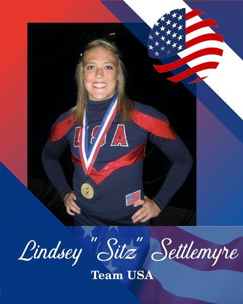 Lindsey "Sitz" Settlemyre in USA uniform, smiling with medal and patriotic USA backdrop
