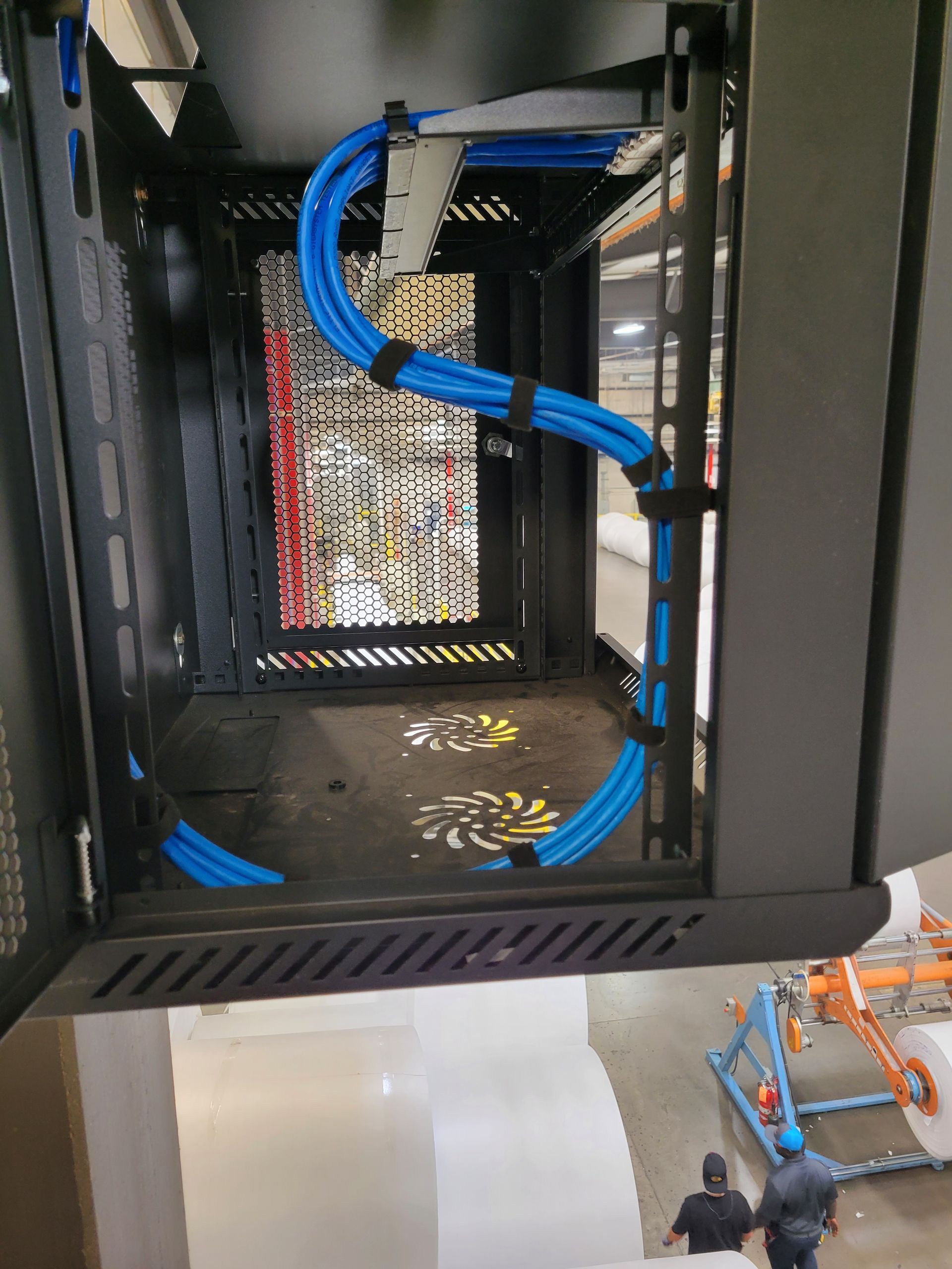 A server rack with blue wires coming out of it