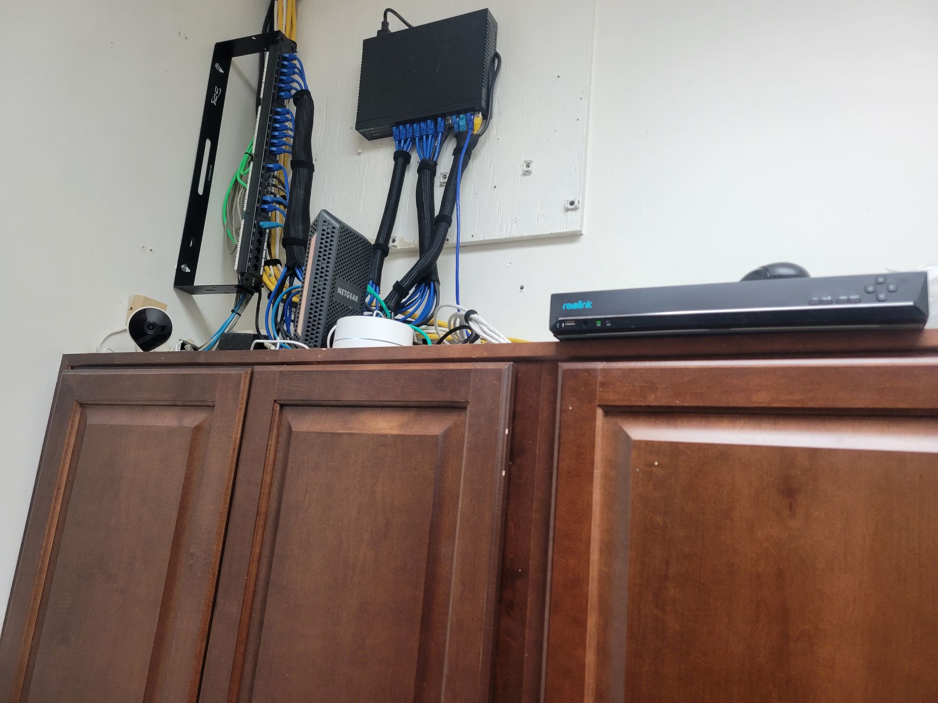 A wooden cabinet with a router on top of it