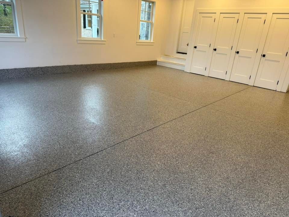 Empty beige room with speckled gray floor and white closet doors