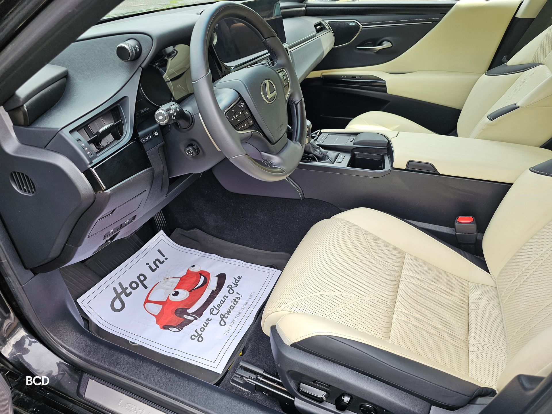 Interior of a Lexus with cream-colored seats. A