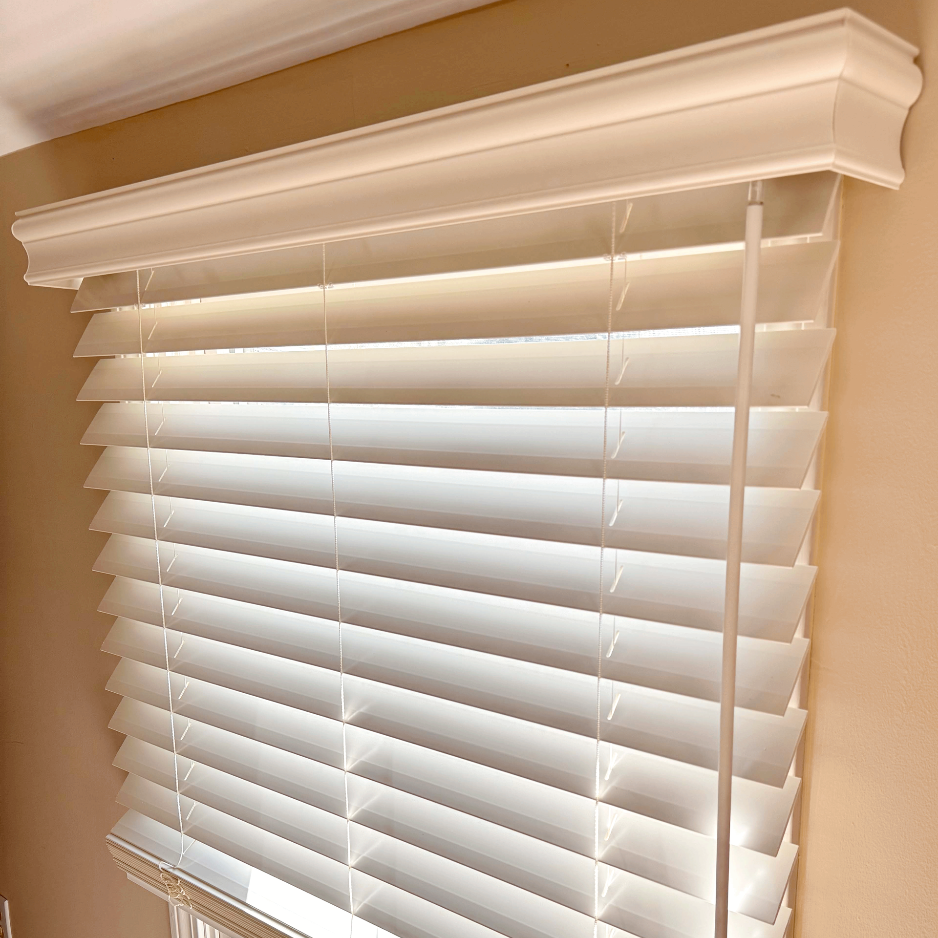 A close up of a window with blinds on it.