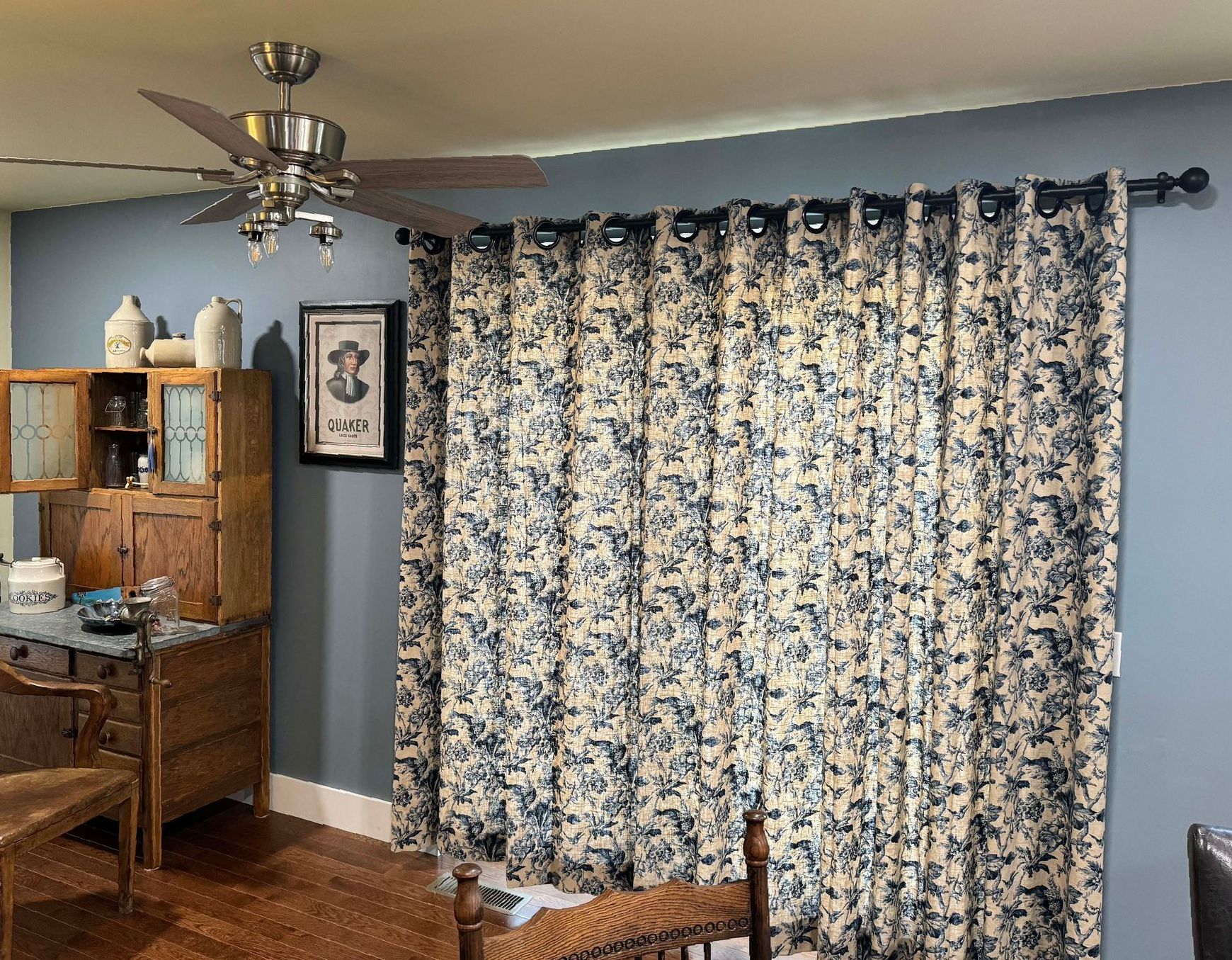 A close up of a window with curtains and tassels
