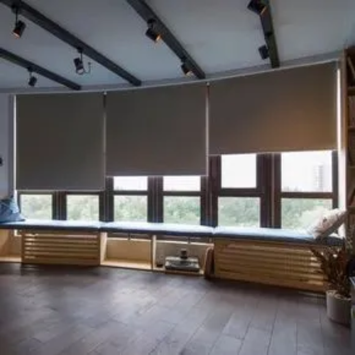 A living room with a lot of windows and blinds.