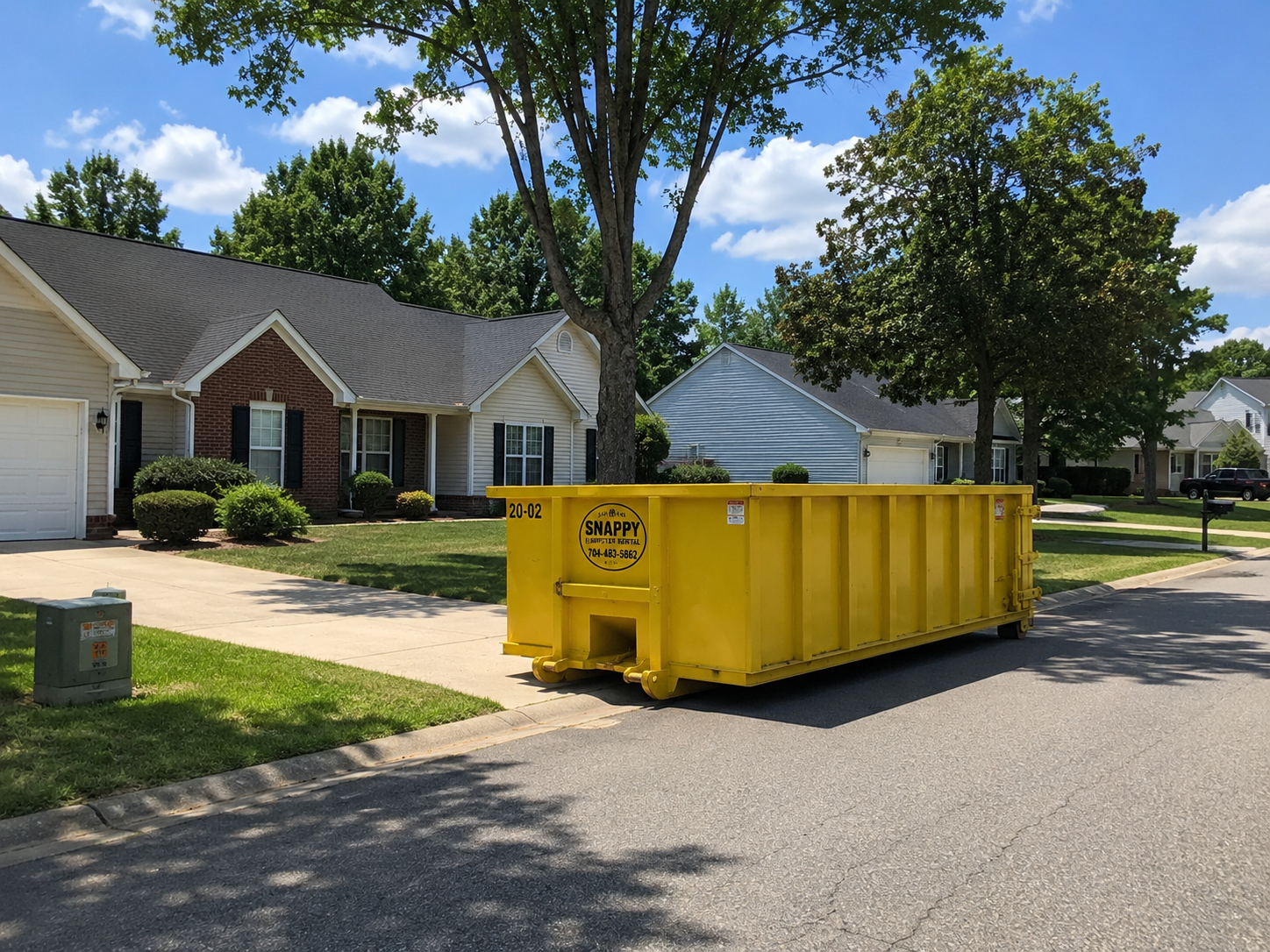 Yellow dumpster placed on a residential street in Stallings, NC