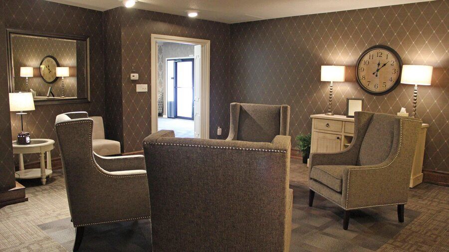 Family visitation lounge with armchairs at Campbell-Aman Funeral Home.