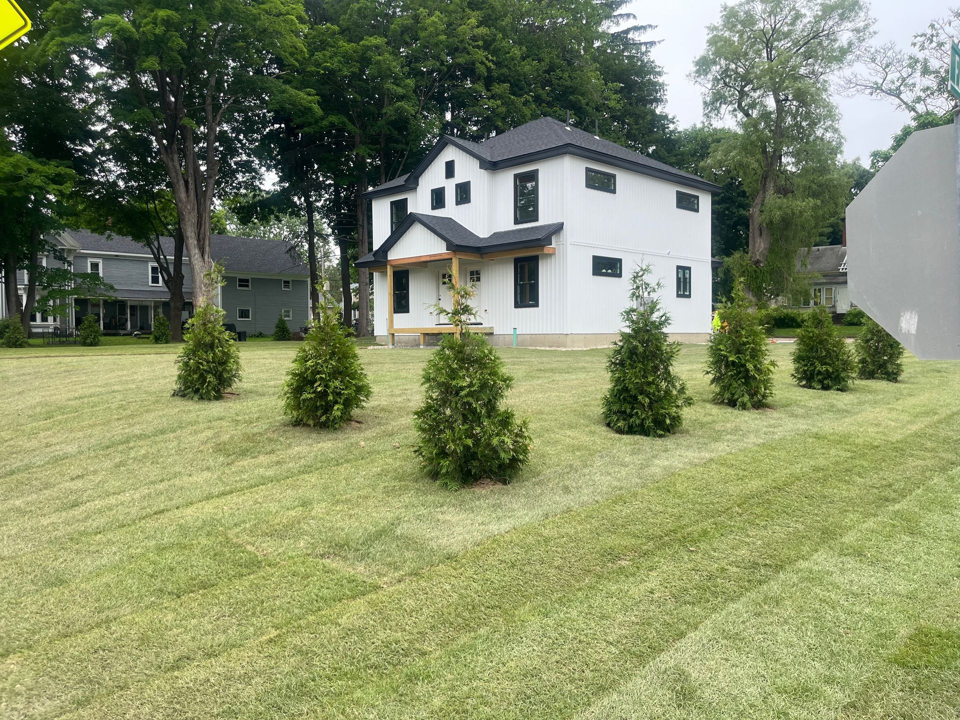 Front of a white house that had land grading done by Kelly Brothers Excavation in Maine
