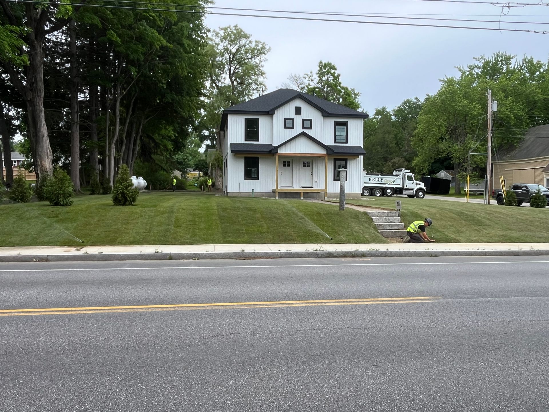 Front of a white house that had land grading done by Kelly Brothers Excavation in Maine