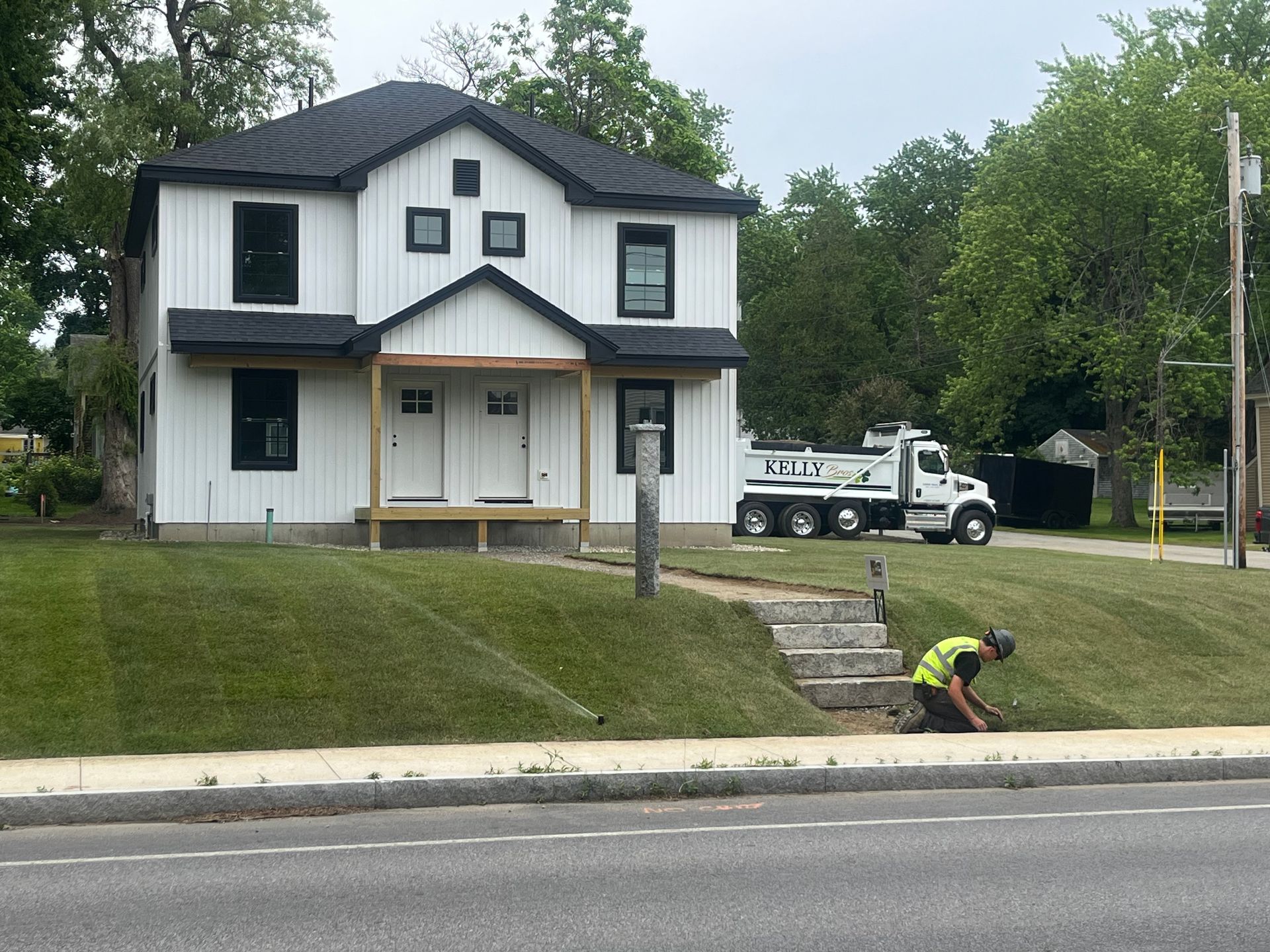 Front of a white house that had land grading done by Kelly Brothers Excavation in Maine