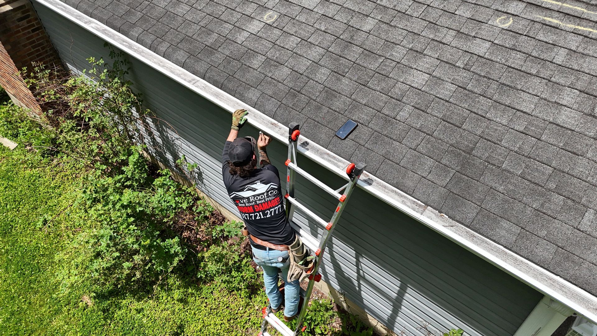 Person on a ladder repairing a roof