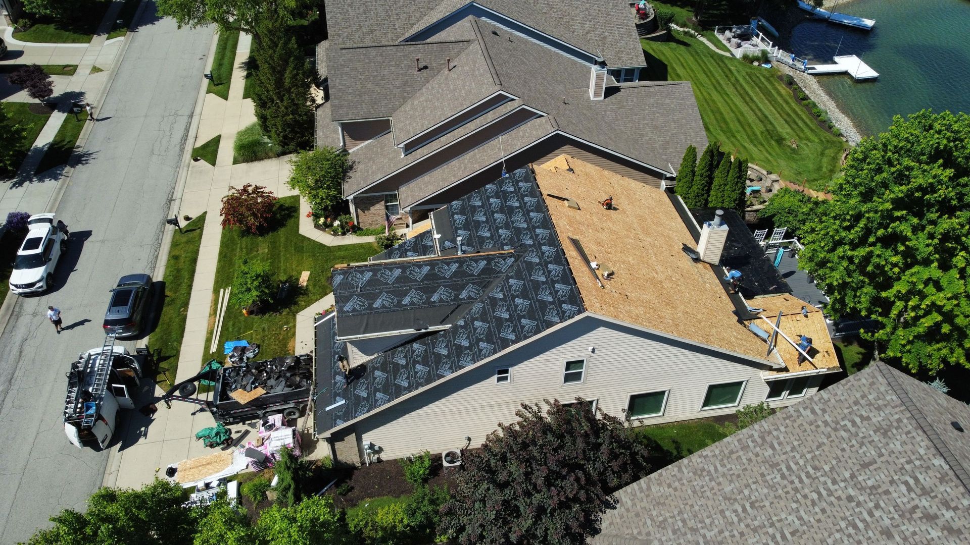 Aerial view of a house undergoing roof replacement