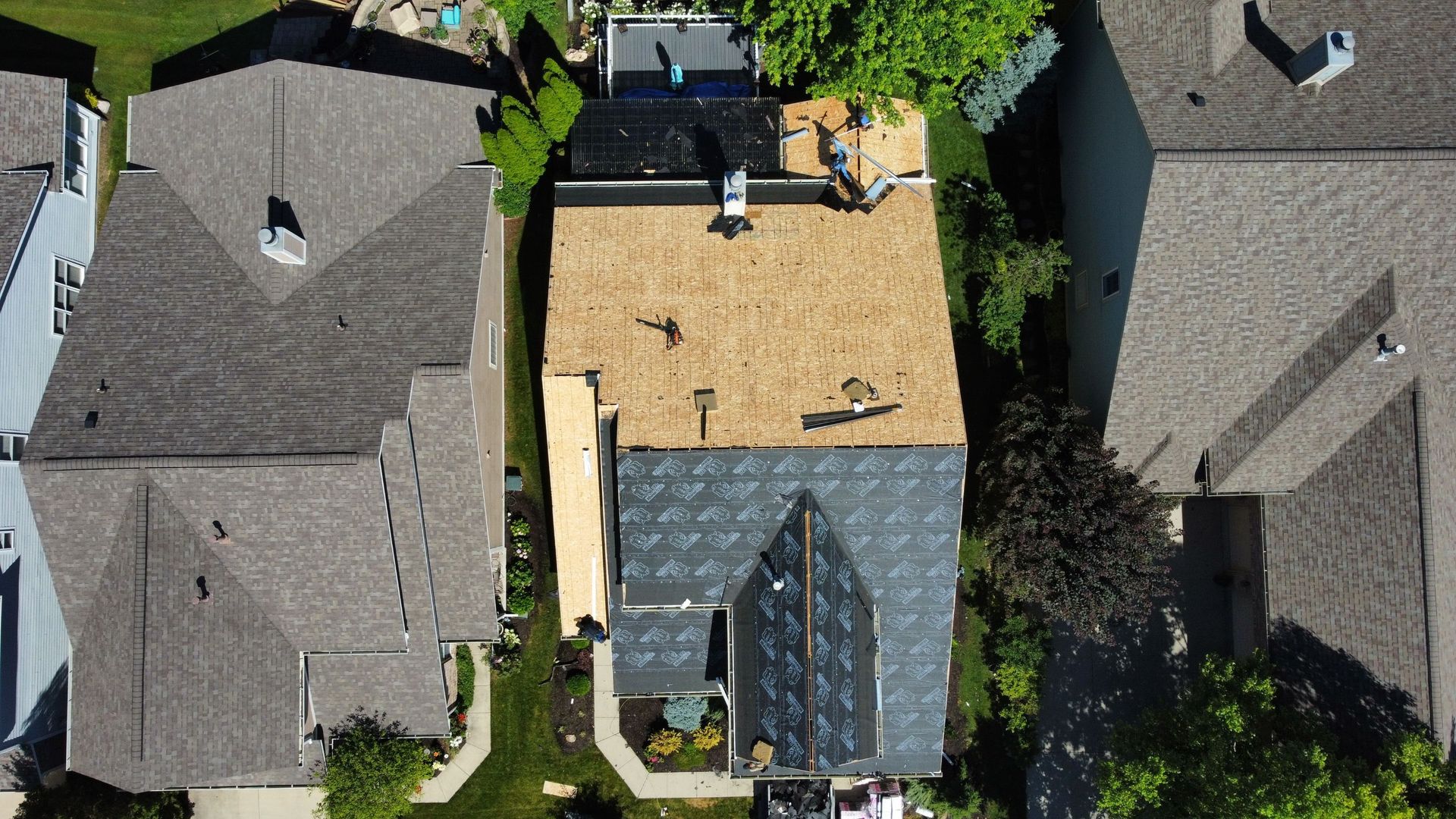 Aerial view of a house undergoing roof replacement