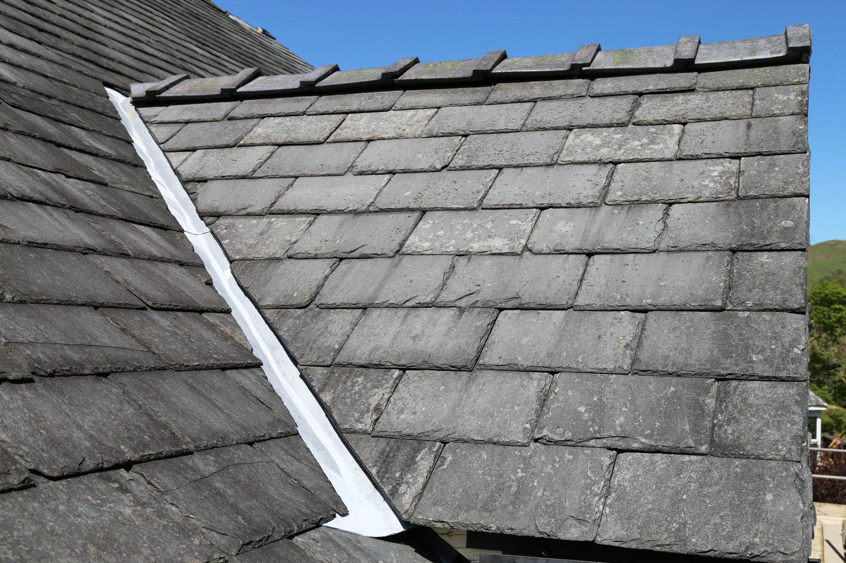 Slate roof with a white repair strip along the center seam