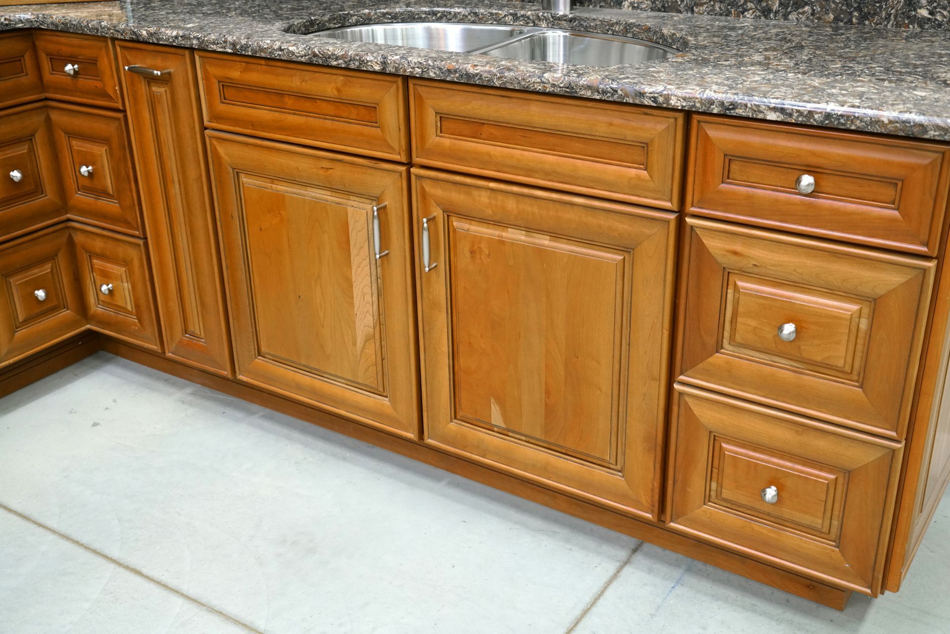 A kitchen with wooden cabinets and granite counter tops