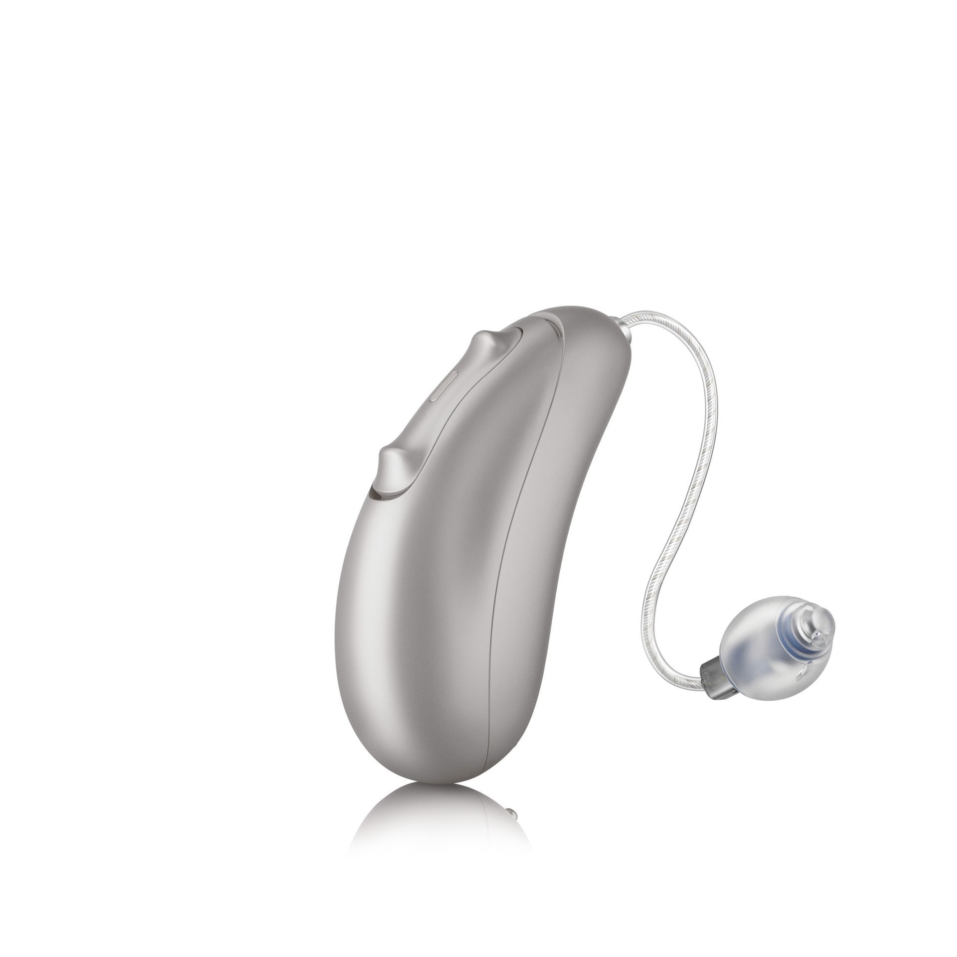 A silver hearing aid is sitting on a white surface.