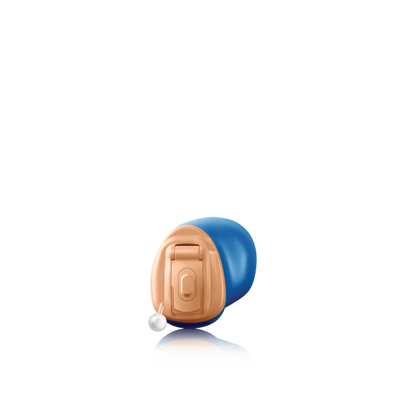 A hearing aid is sitting on a white surface.