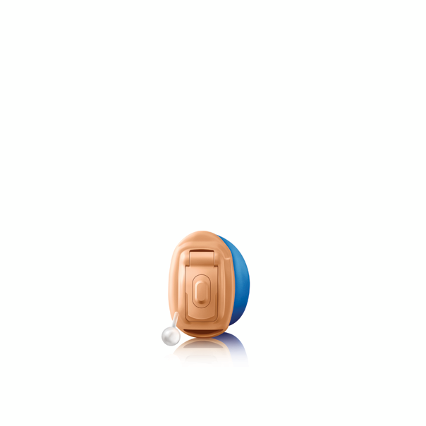 A hearing aid is sitting on a white surface.