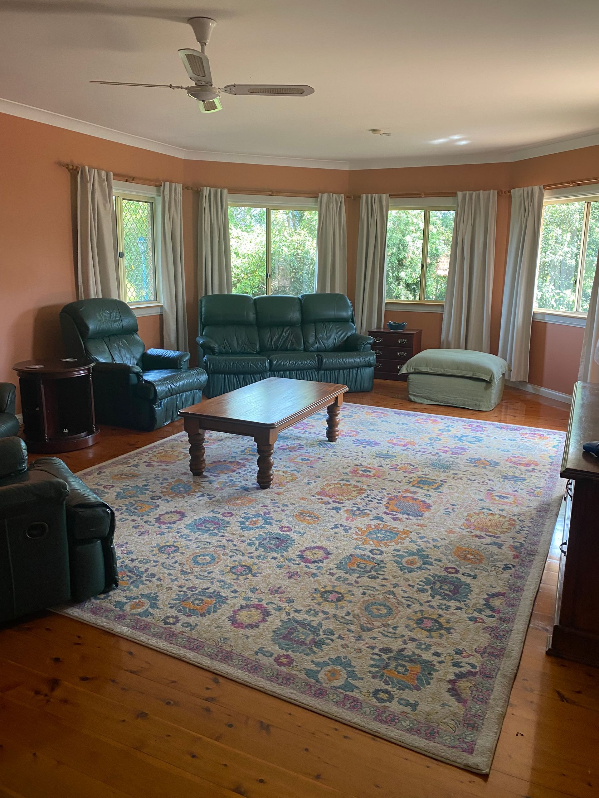 A living room filled with furniture and a rug.