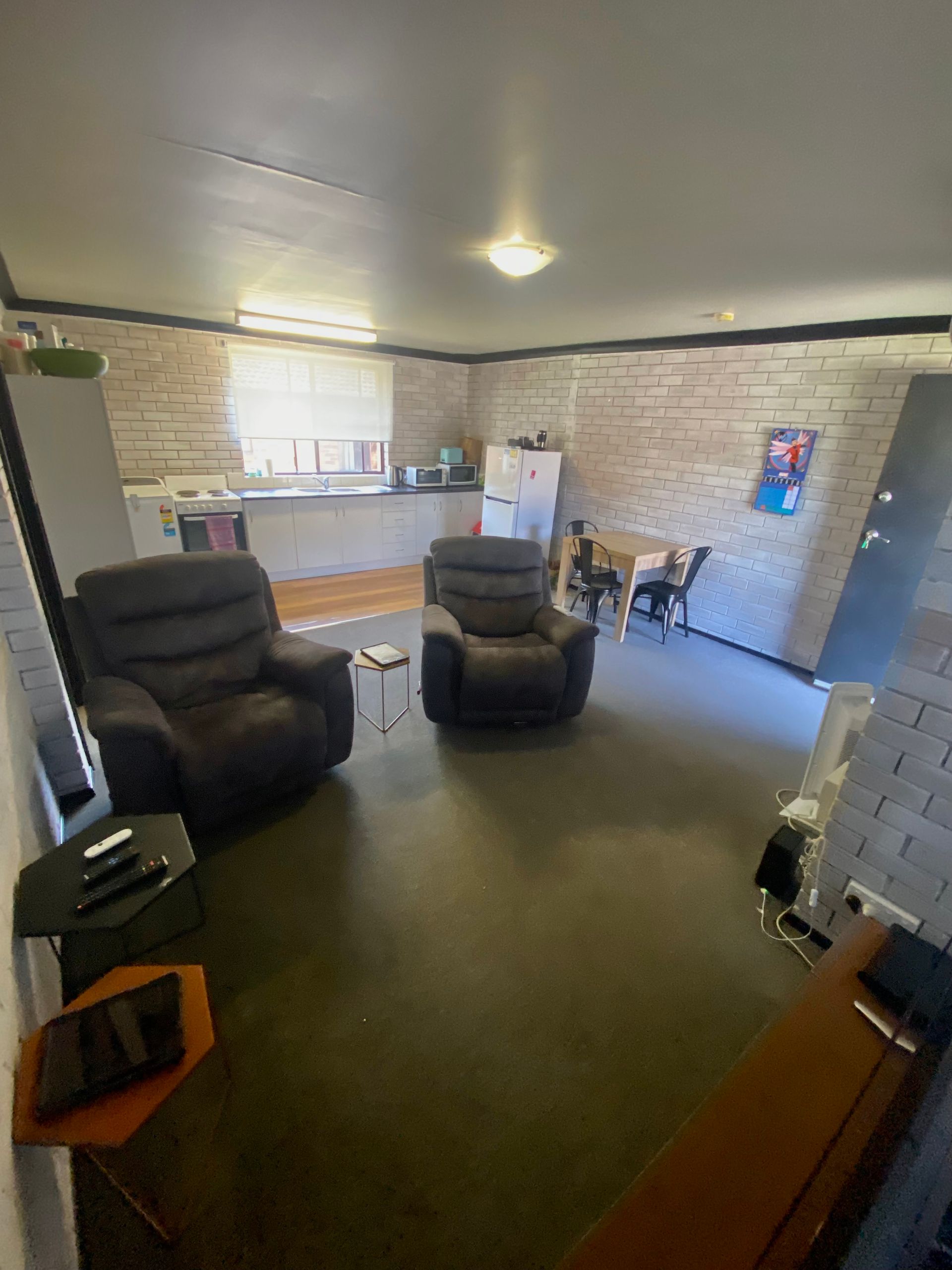 A living room with two recliner chairs and a table.