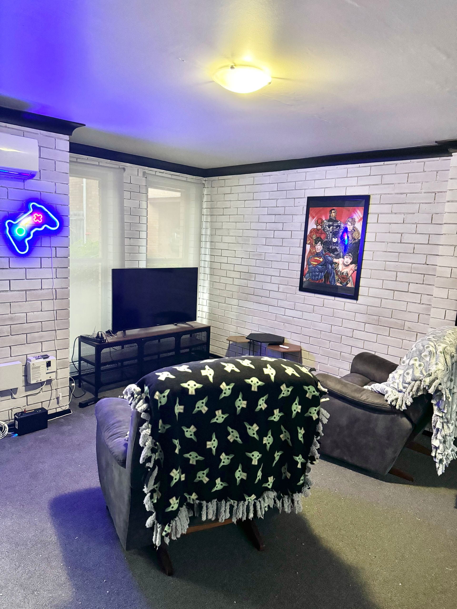 A living room with a couch , chair , and television.