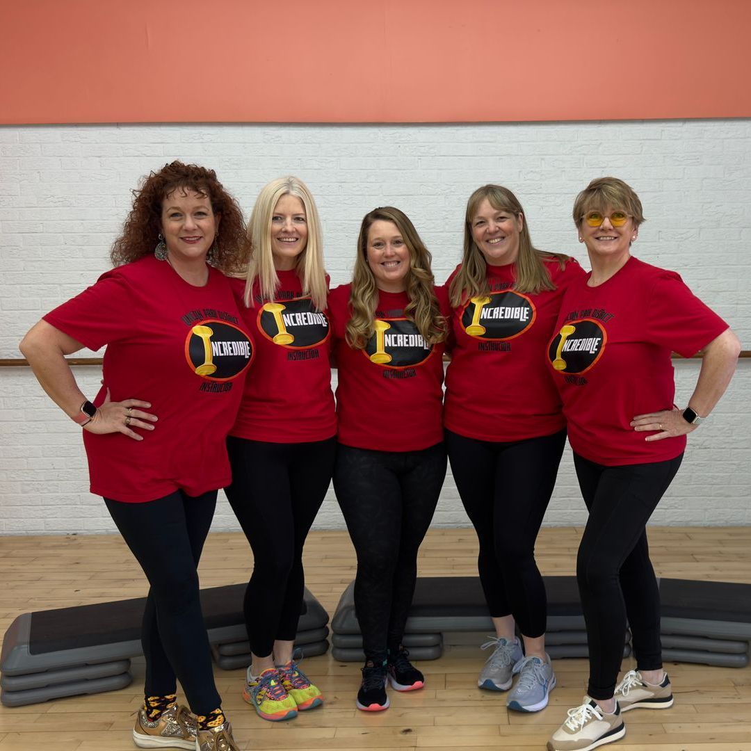A group of women are posing for a picture and they are all wearing red shirts