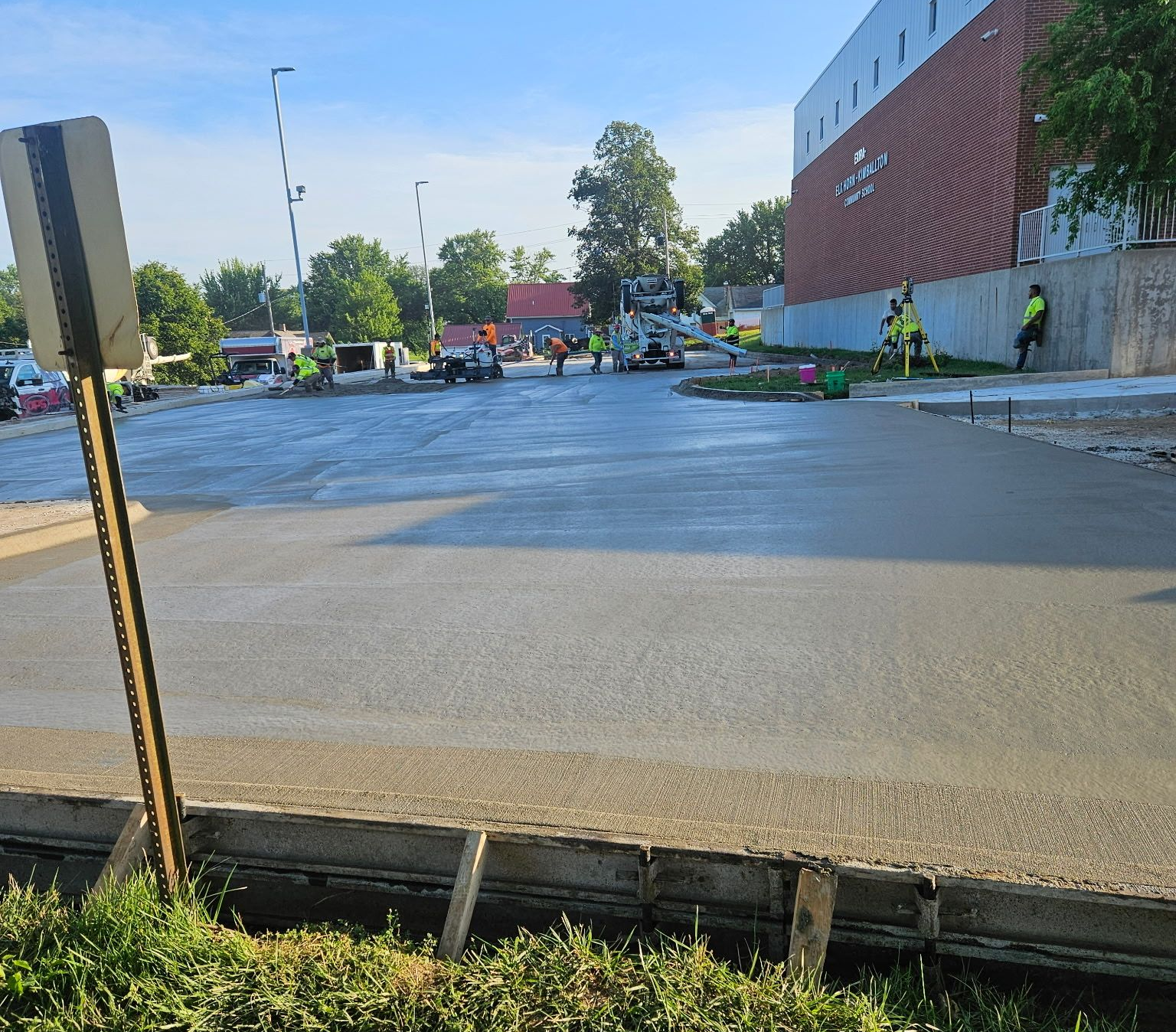 Concrete parking lot freshly poured and smoothly finished, ready for curing and use.