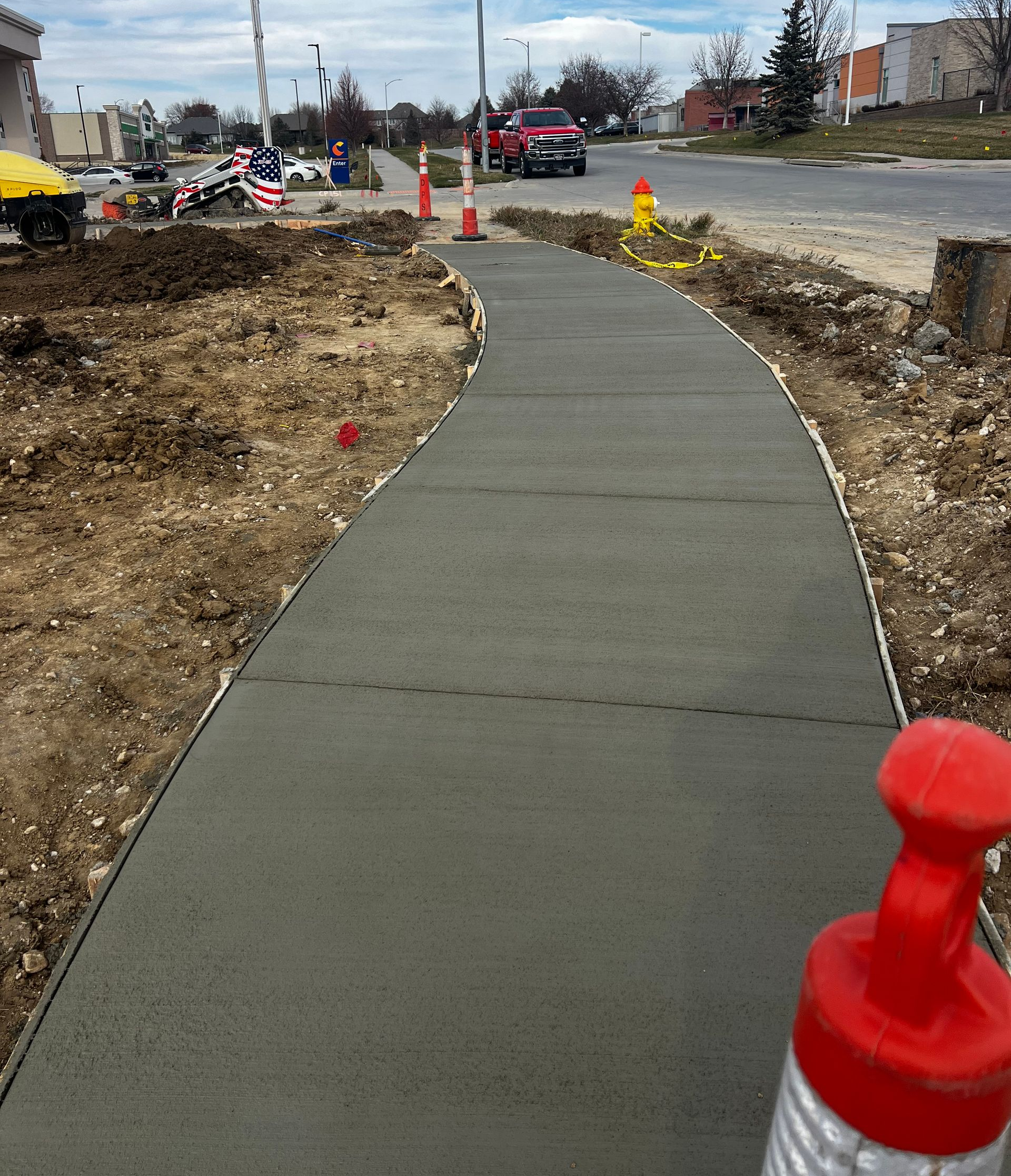 Concrete sidewalk freshly poured and smoothly finished, ready for curing and use.