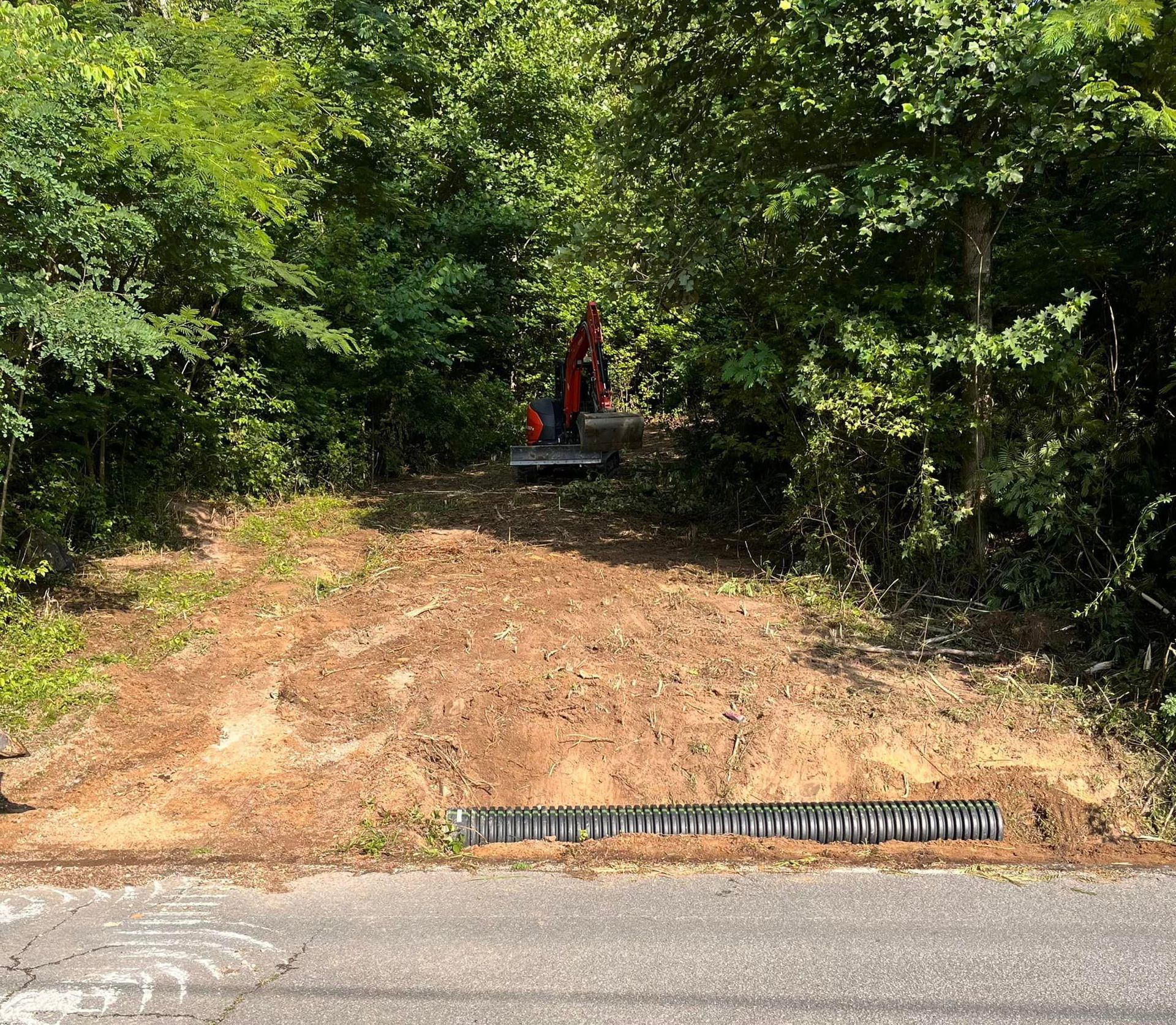 A septic tank is being installed in the dirt in a backyard.