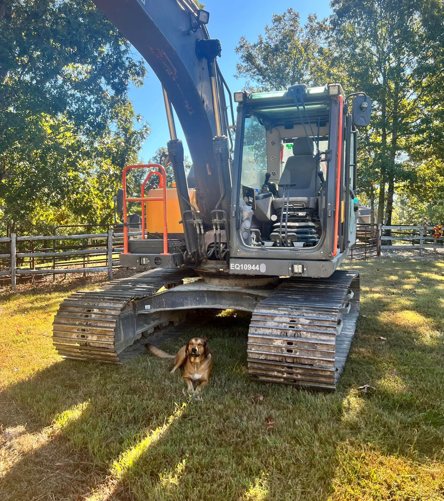 A drain pipe is being installed in the dirt in a field.