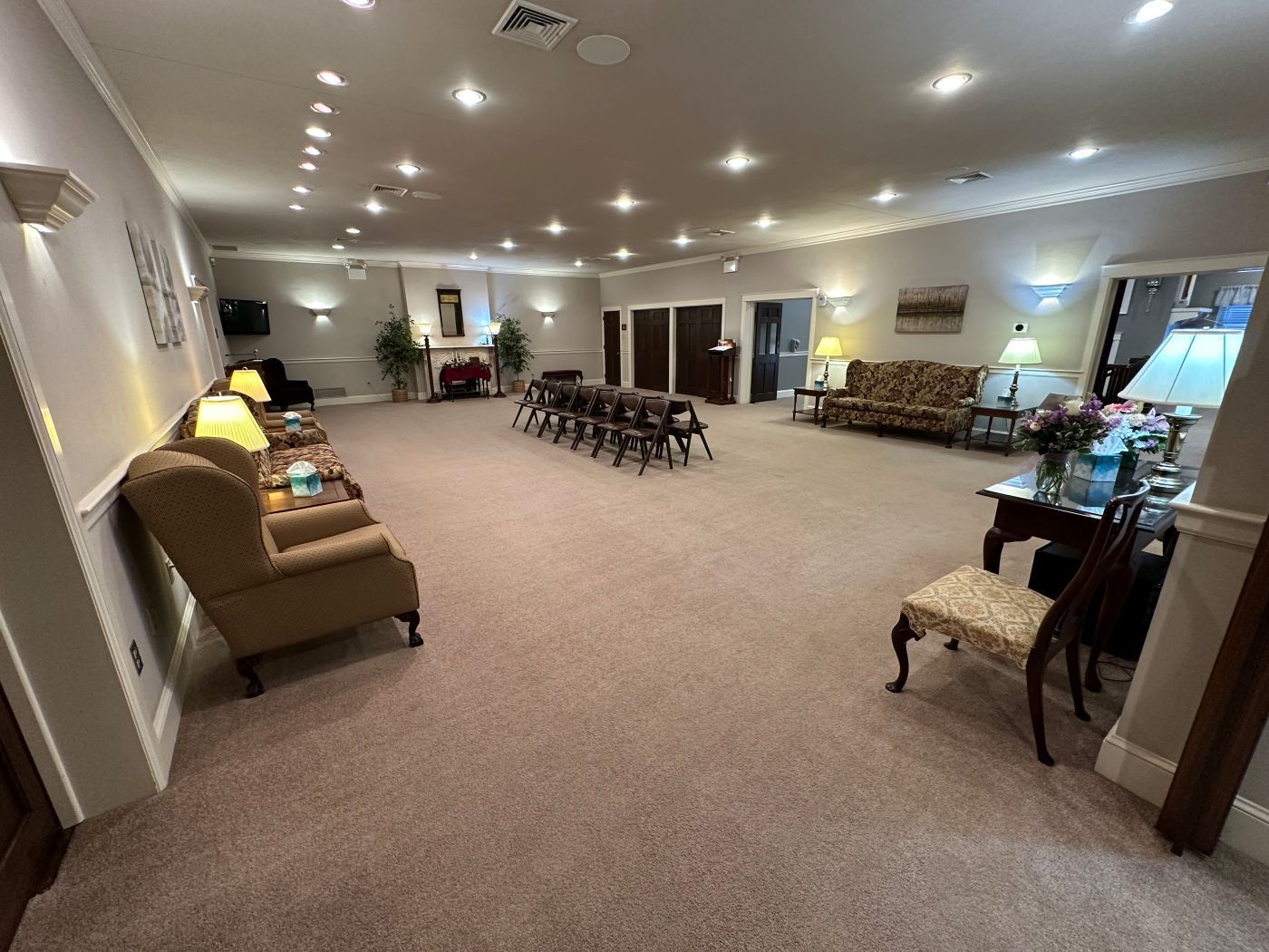 A large room with a lot of chairs and tables in it.