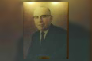 A blurry picture of a man in a suit and tie