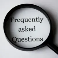 Magnifying glass highlighting the words “Frequently asked Questions” on a white background