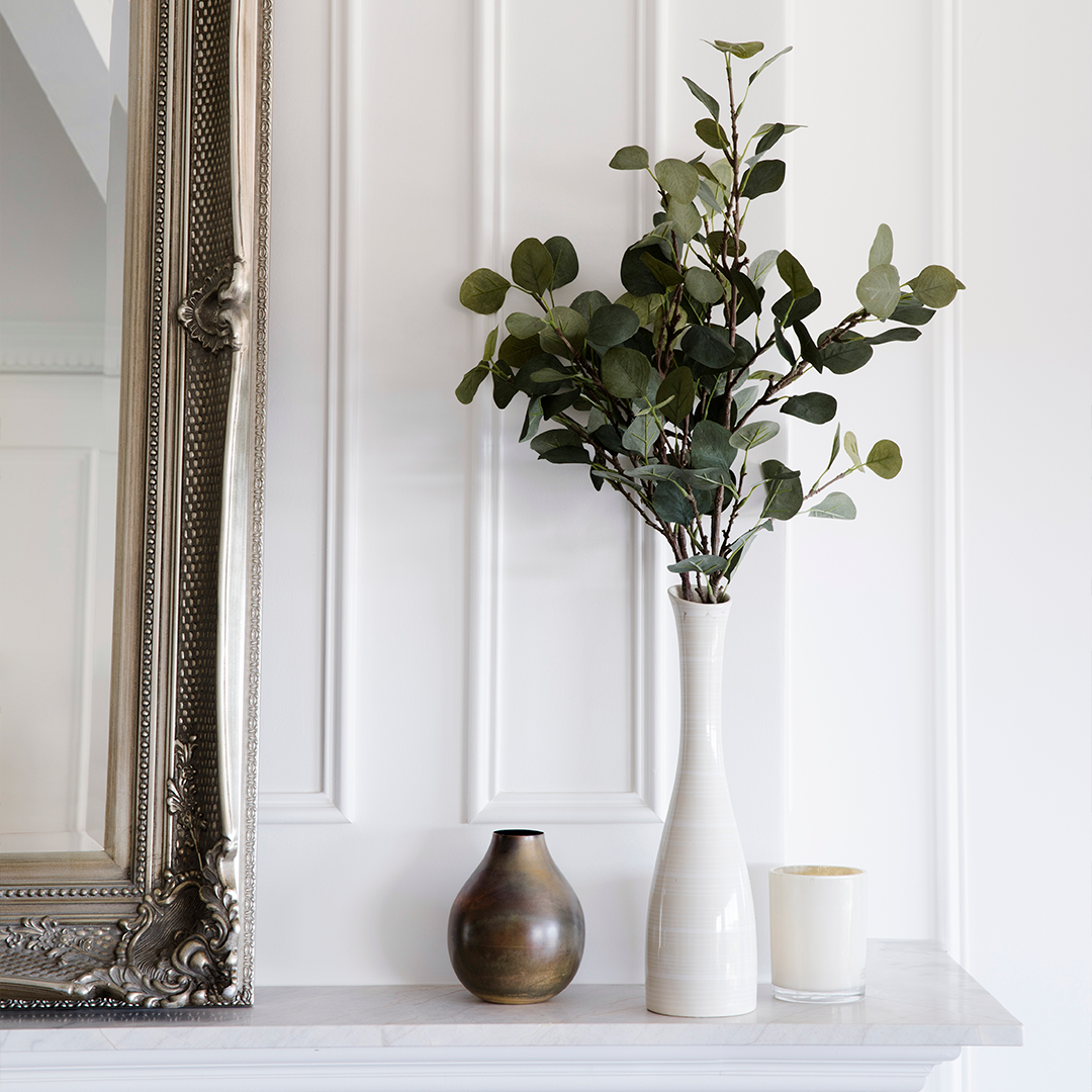 A White Vase With Green Leaves Sits on a Mantel With a Gold Vase — Burmah Constructions In Kangaroo Valley, NSW