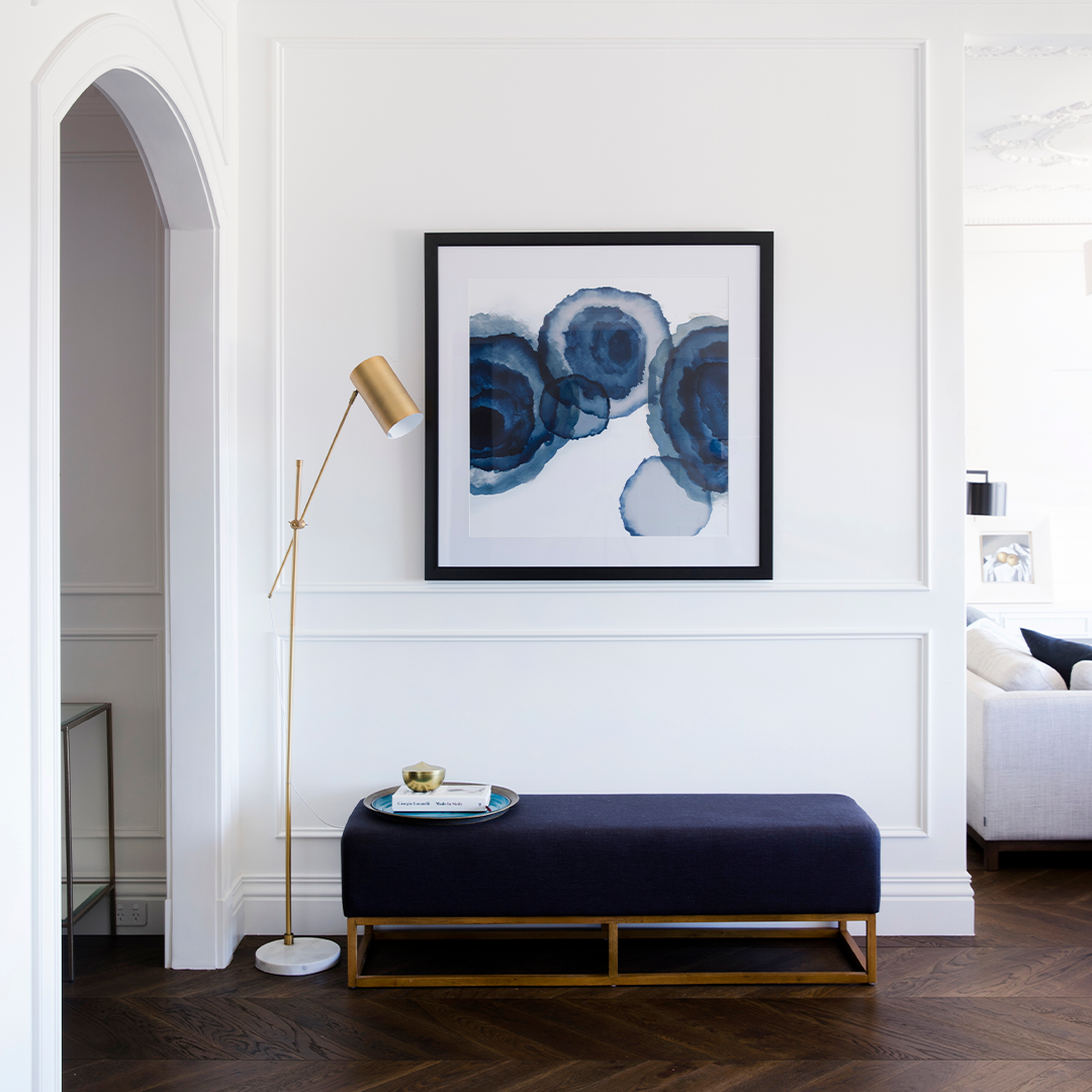 Hallway With a Navy Bench, Gold Lamp, and Abstract Blue Artwork — Burmah Constructions In Kangaroo Valley, NSW