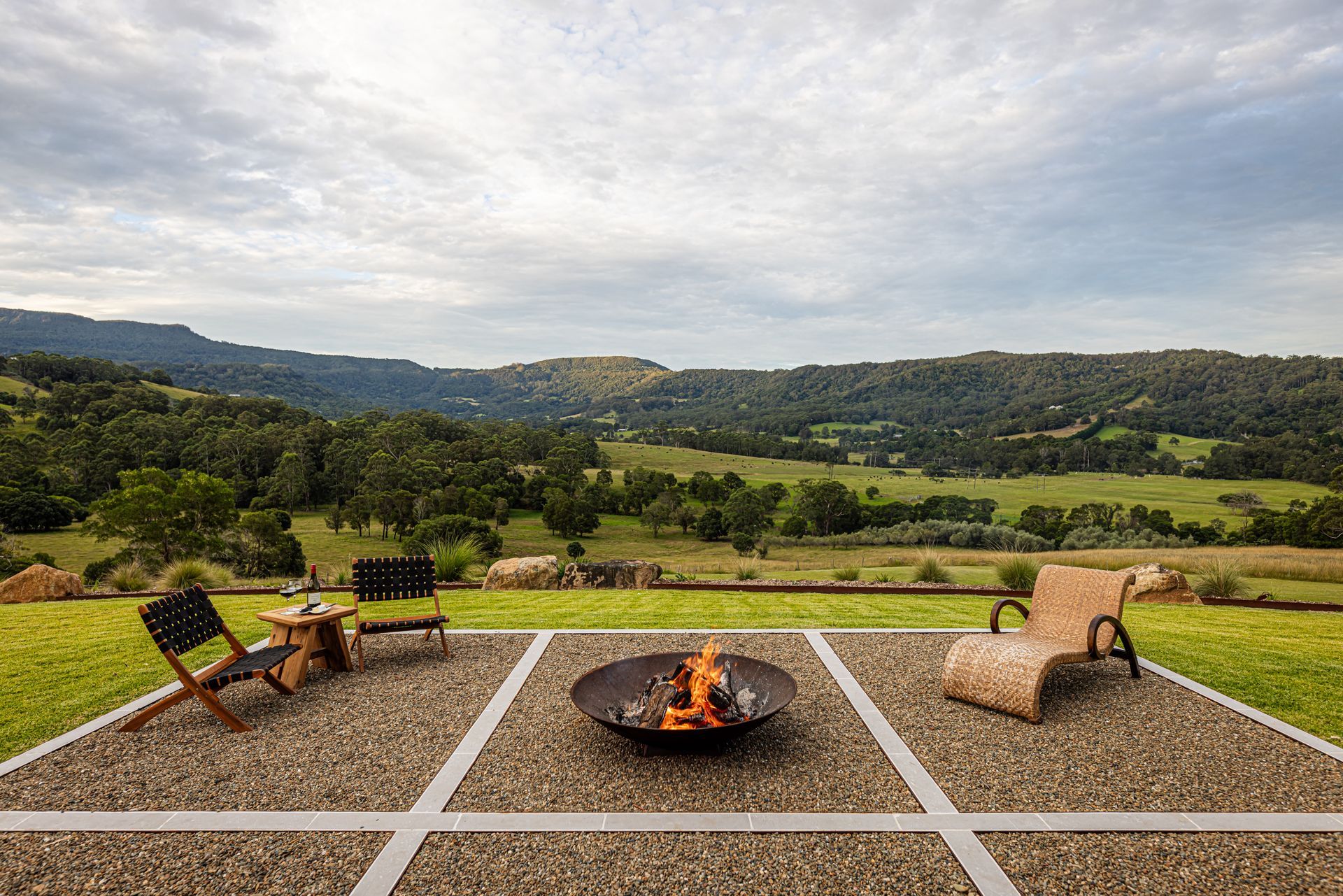 Patio Fire Pit With Chairs Overlooking a Green Valley and Rolling Hills — Burmah Constructions In Kangaroo Valley, NSW