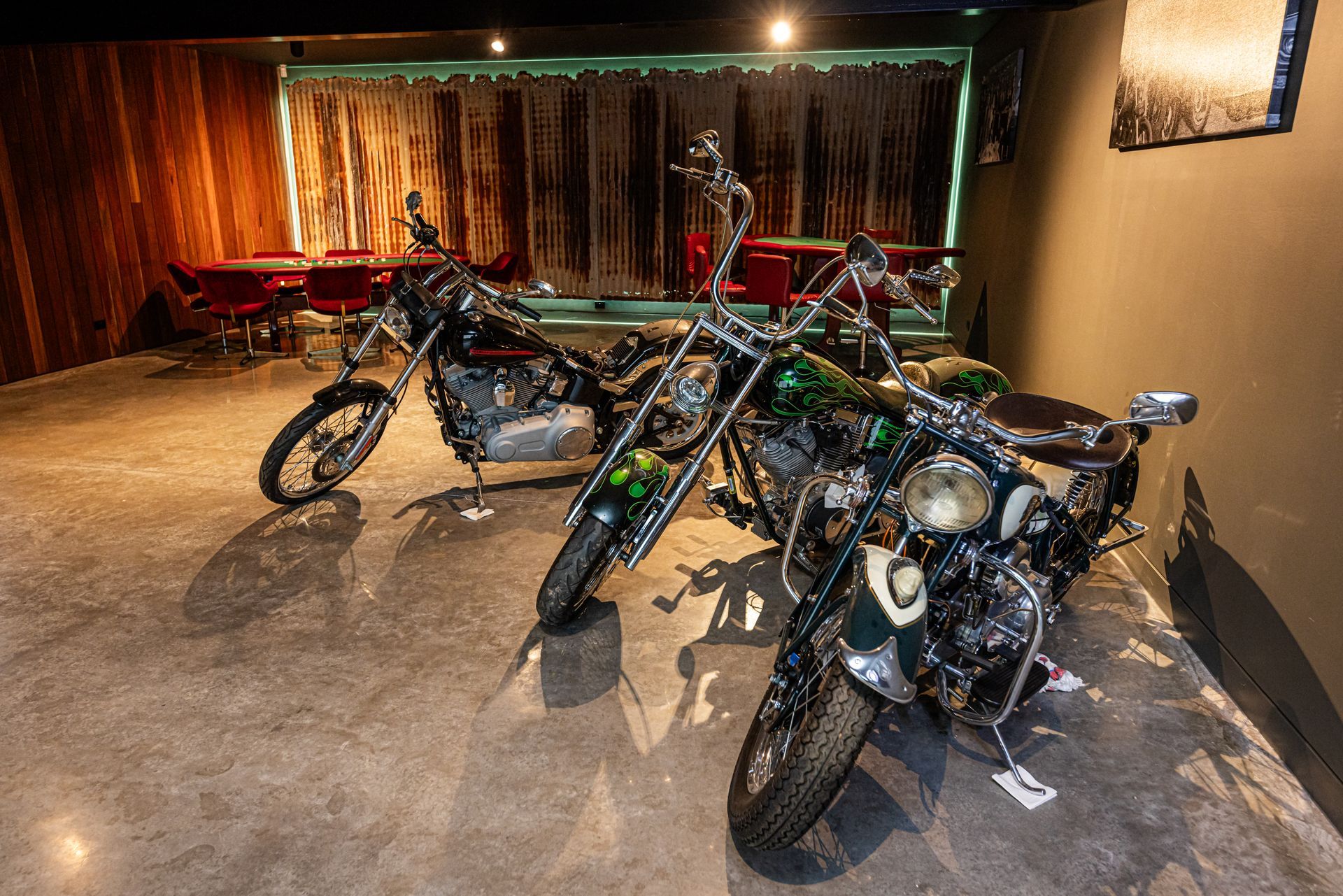 Three Dirt Bikes Parked in a Dim Garage With Red Bench — Burmah Constructions In Kangaroo Valley, NSW