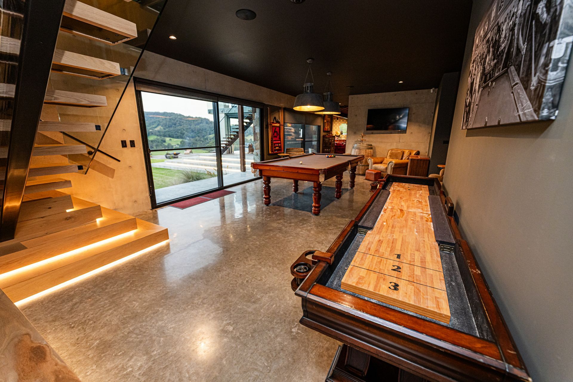 Modern Lobby With Wood Staircase, Long Bench, Pool Table, and Large Glass Doors — Burmah Constructions In Kangaroo Valley, NSW