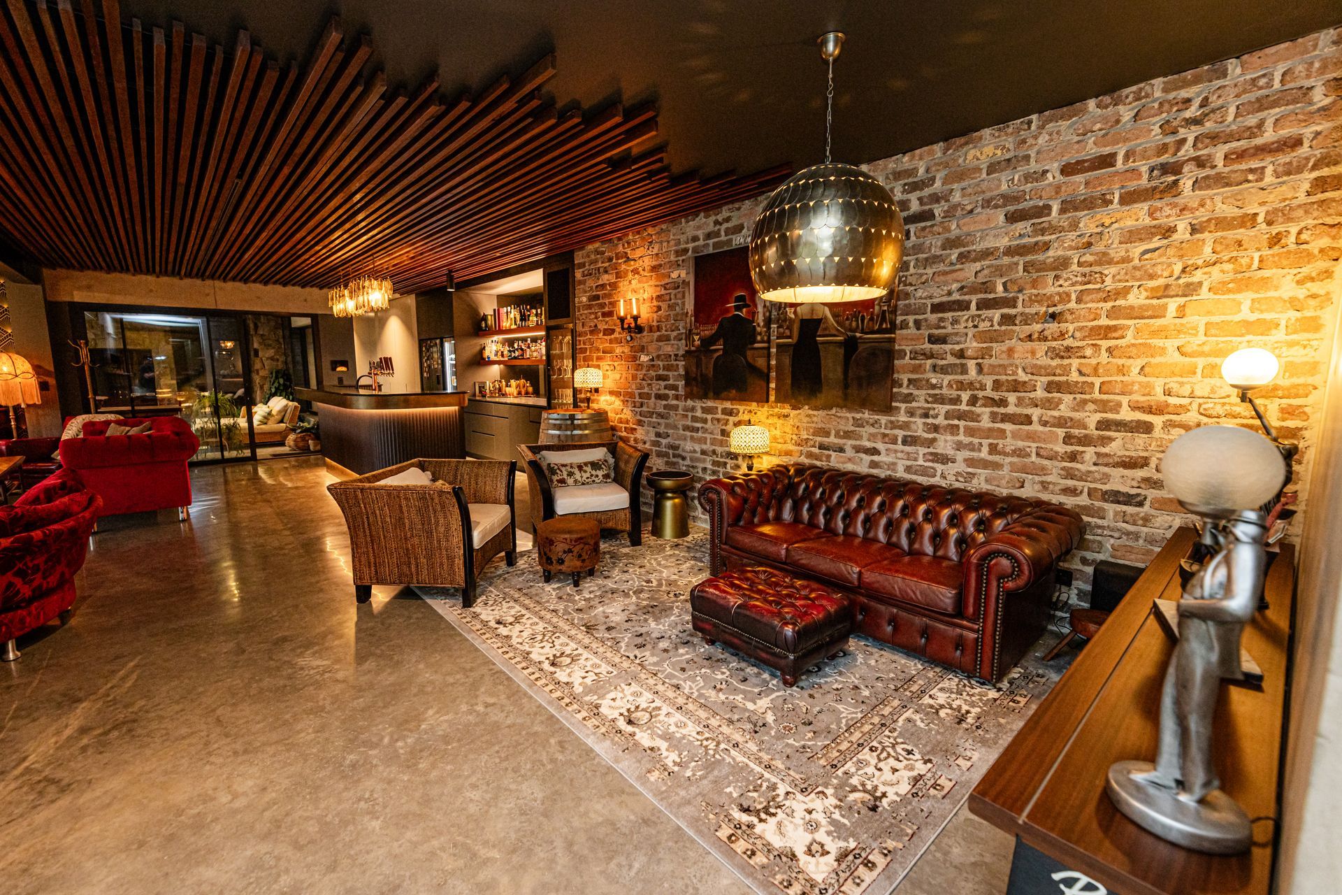 Cozy Brick-walled Lounge With Leather Seating, Warm Lighting, and Patterned Rug — Burmah Constructions In Kangaroo Valley, NSW