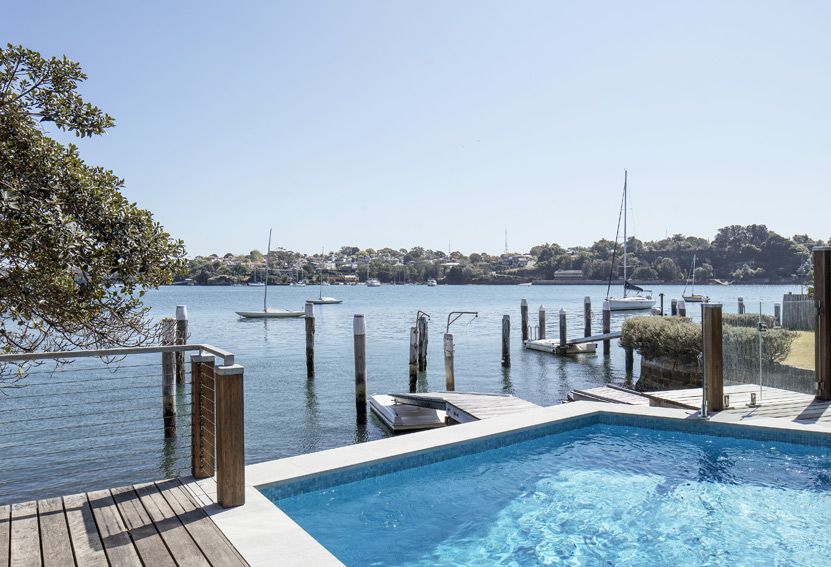 Pool Overlooking a Harbor With Docks and Boats on a Sunny Day — Burmah Constructions In Kangaroo Valley, NSW
