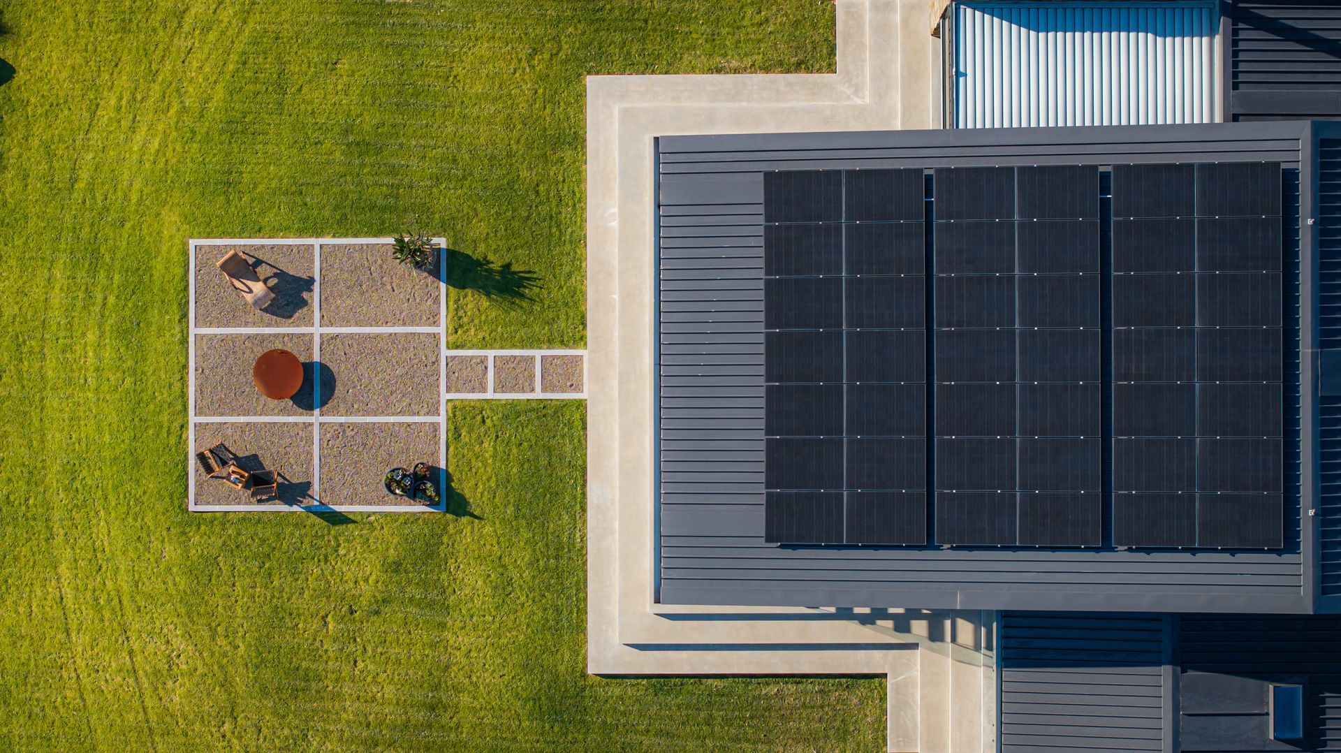 Aerial View of a Rooftop With Solar Panels Beside a Grassy Yard — Burmah Constructions In Kangaroo Valley, NSW