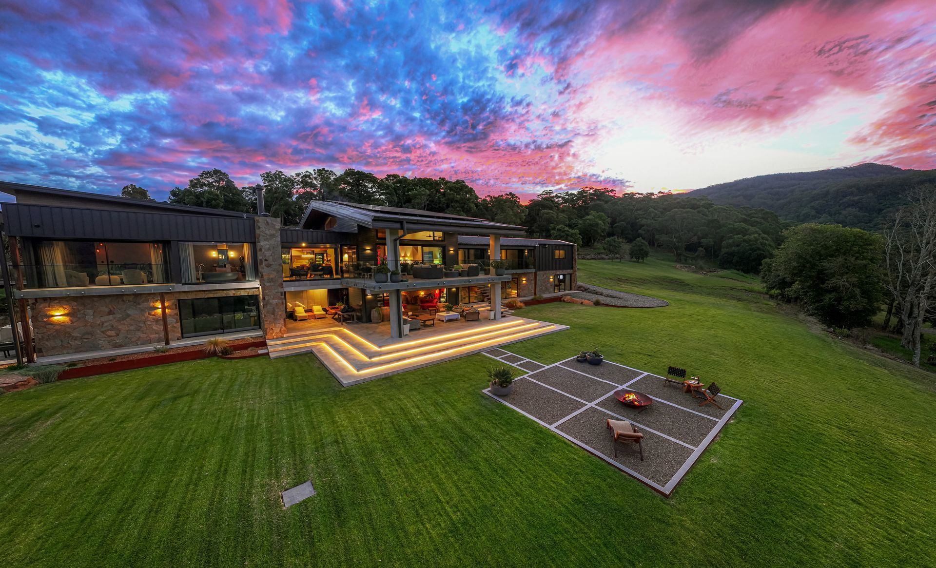 Modern House With Lit Patio, Green Lawn, and a Vivid Pink-blue Sunset Sky — Burmah Constructions In Kangaroo Valley, NSW