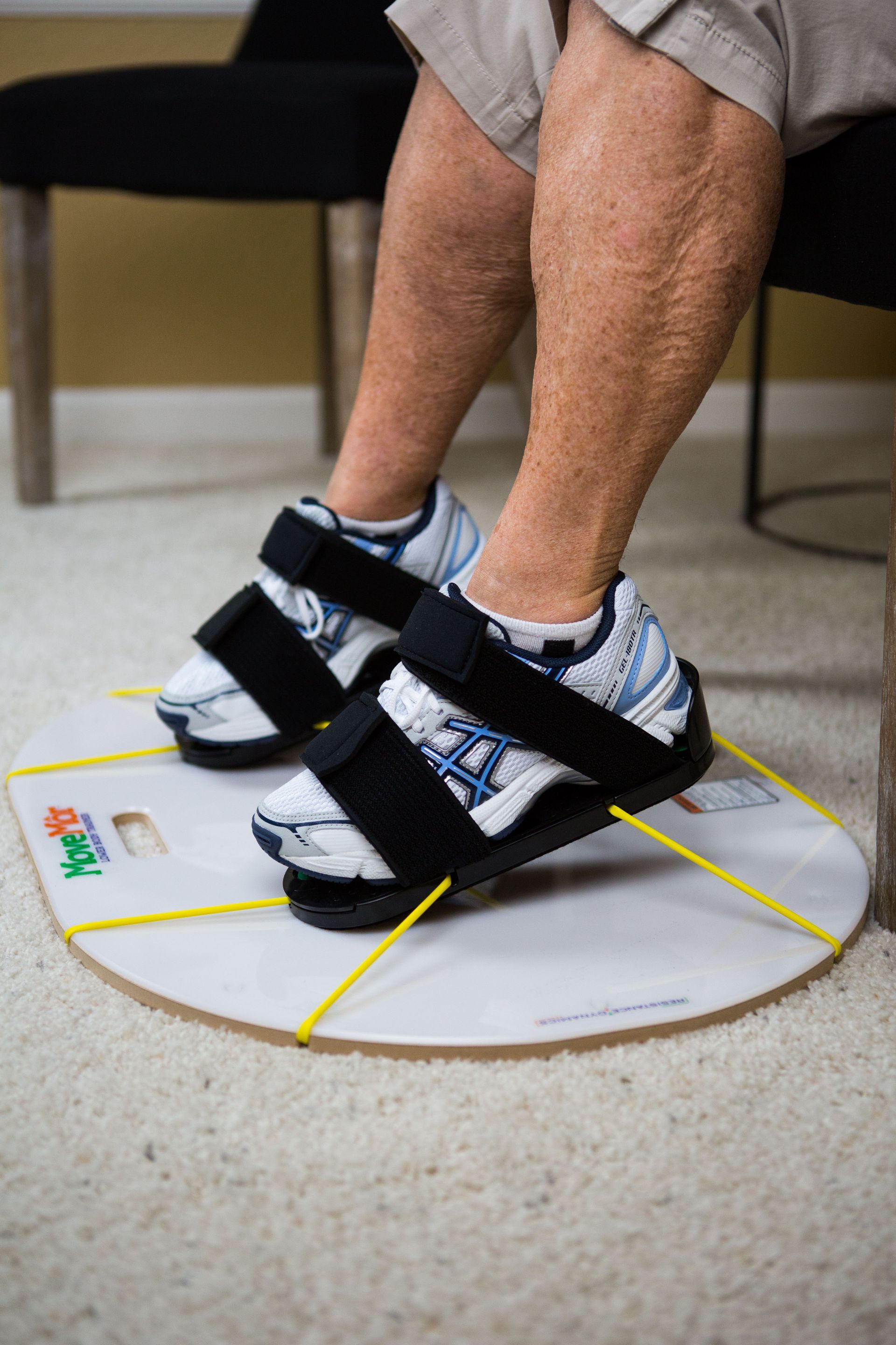 a person wearing a pair of sandals is sitting on a chair .