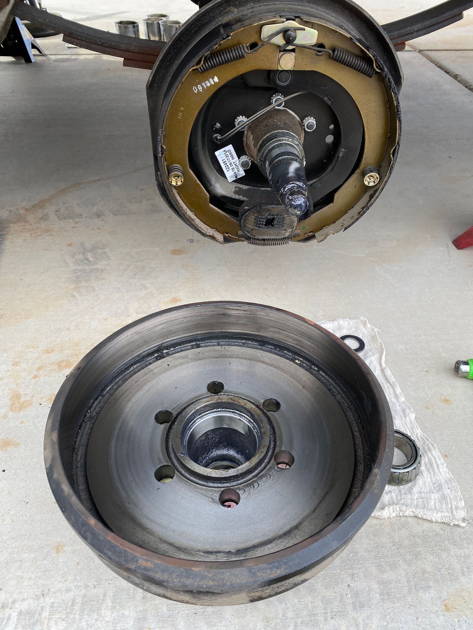 Damaged aircraft wheel assembly with detached wheel hub lying on a concrete floor