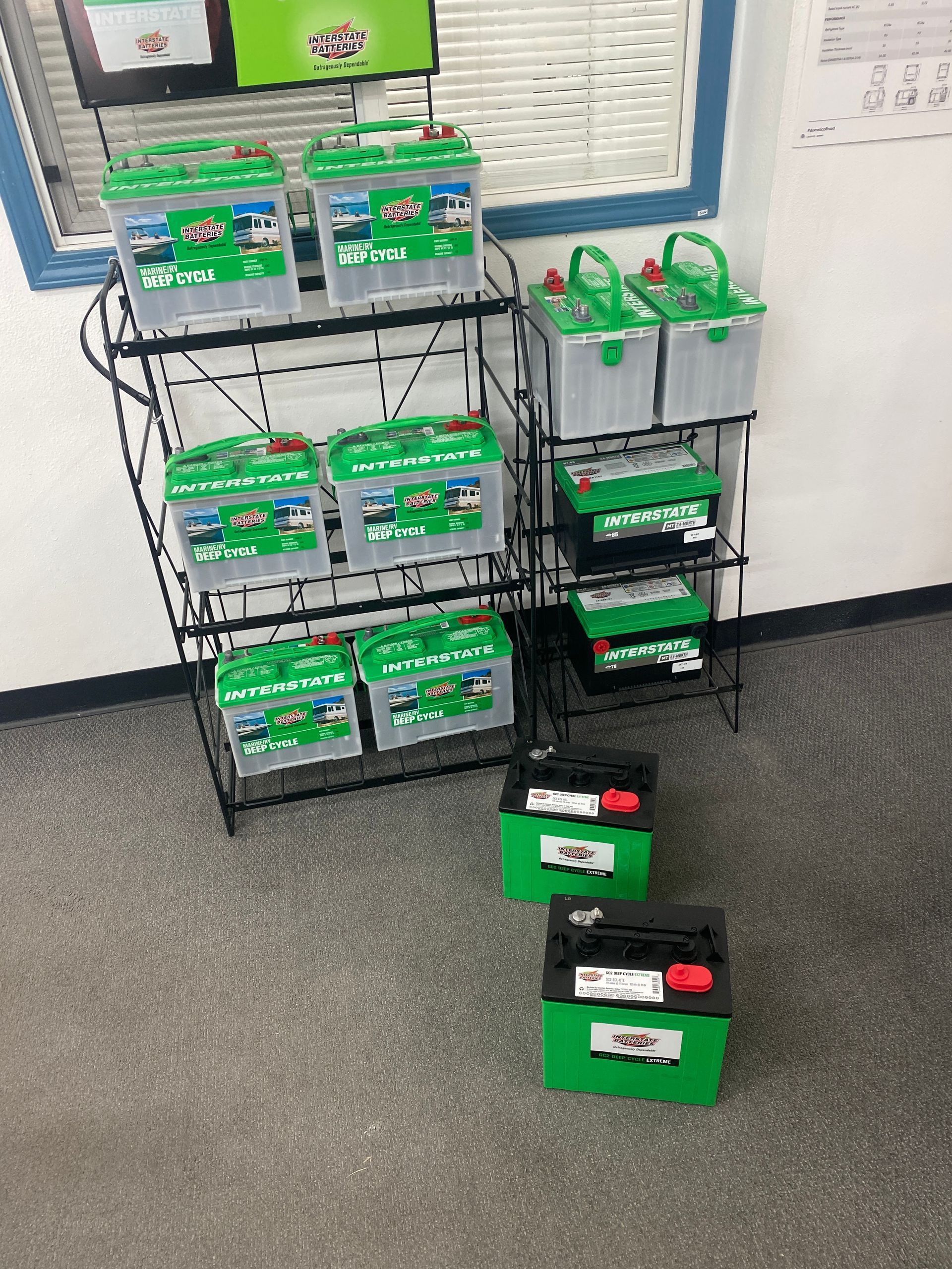 Green packaged goods displayed on black wire racks in a store aisle