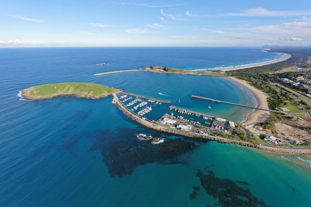 An Aerial View of A Marina and A Small Island in The Middle of The Ocean — Thompson's Farm Gear In Coffs Harbour, NSW