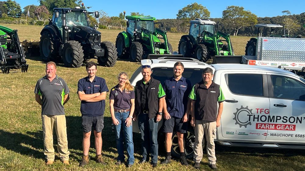 Five Mens and One Women Workers with Thompson White Pickup and Tractor — Thompson's Farm Gear In Wauchope, NSW